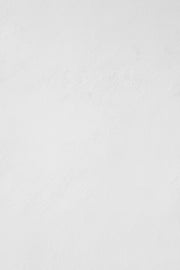 a man riding a snowboard down a snow covered slope