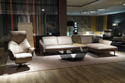 a living room filled with furniture on top of a hard wood floor